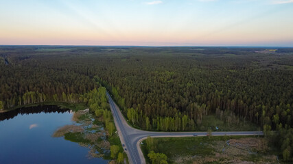Fototapeta premium Crossroads in the forest by the lake from a height