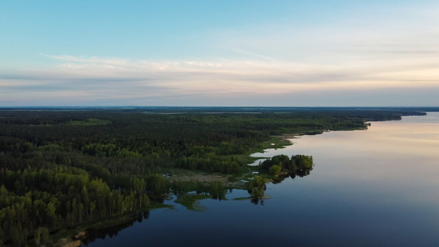 Green Shore Of The Lake. Forest And Water Meet. View From Above