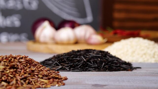 Closeup piles of various aromatic seeds placed on table in cozy kitchen at home