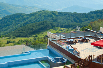 Fototapeta na wymiar Swimming pool with amazing mountain view in Kopaonik resort, Serbia