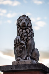 statue of a lion in fron of the sunset
