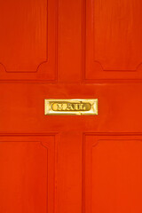Gold Mailbox on Red Door