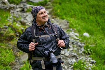 Hiker man with backpack on a mountain trail