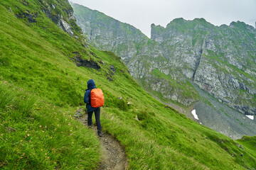 Fototapeta premium Lady hiker on a trail in the mountains