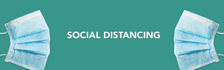 Two masks spaced for social distancing. Face mask is represented social distancing to prevent from...