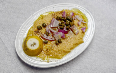 Fava beans puree with onions, olive oil and capers, traditional Greek vegan plate