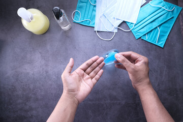 Top view of young man hand using sanitizer gel for preventing virus 