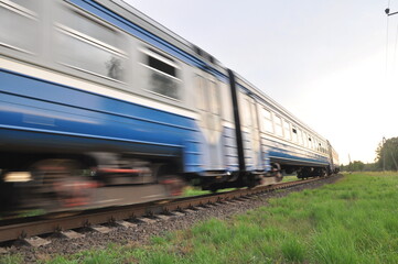 A high-speed diesel train moves quickly by rail. Blur