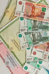 documents and paper money are on the table inscription birth and marriage certificate