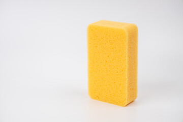 Sponge on white background. Yellow household cleaning sponge.