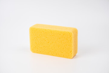 Sponge on white background. Yellow household cleaning sponge.