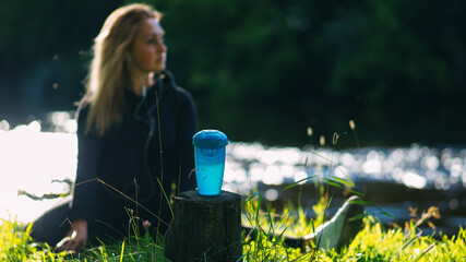 Sports shaker, selective focus. A young woman is engaged in outdoor sports. Summer active lifestyle
