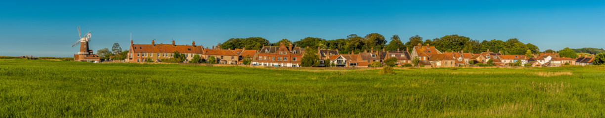 Fototapeta na wymiar A panorama view across the marshes of the village of Cley, Norfolk, UK