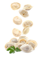 Many tasty dumplings falling on white background
