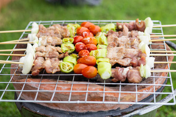 A variety of delicious grilled meats mixed with vegetables rather than charcoal on the barbecue are ready to be given.
