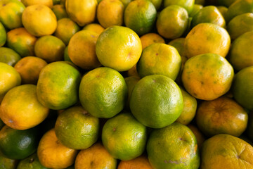 orange fruit stacked on the marketplace