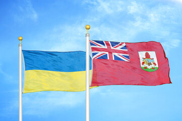 Ukraine and Bermuda two flags on flagpoles and blue sky