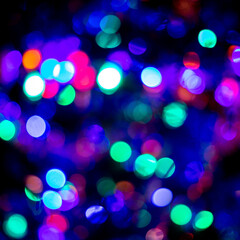 Trendy in 2021 Christmas or New Year festive blue and purple bokeh on black background. Backdrop or wallpapers.