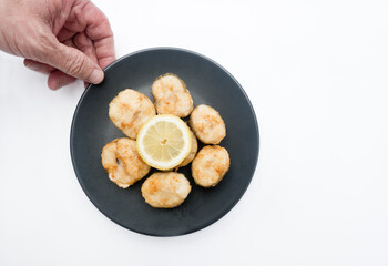 Fried hake with lemon. With white background