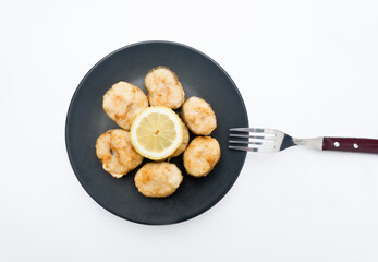 Fried hake with lemon. With white background