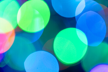 Christmas or New Year festive blue and green bokeh background closeup. Large Xmas macro round bokeh backdrop.