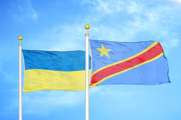 Ukraine and Congo Democratic Republic two flags on flagpoles and blue sky