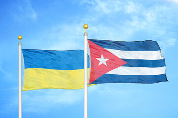 Ukraine and Cuba two flags on flagpoles and blue sky