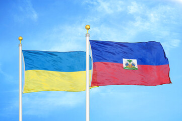 Ukraine and Haiti two flags on flagpoles and blue sky