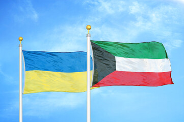 Ukraine and Kuwait two flags on flagpoles and blue sky