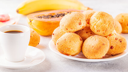 Traditional Brazilian breakfast - cheese bread, coffee, ripe fruit.
