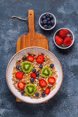 Healthy breakfast, bowl with oat granola and berries.