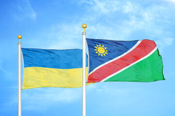 Ukraine and Namibia two flags on flagpoles and blue sky