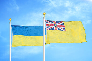 Ukraine and Niue two flags on flagpoles and blue sky