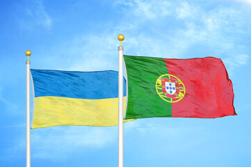 Ukraine and Portugal two flags on flagpoles and blue sky