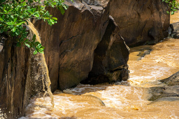 Cliffs with waterfalls during forest floods