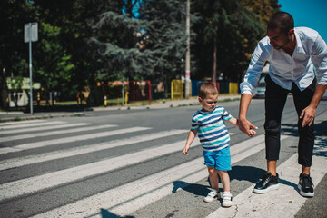 Father and son walking on street Father wearing smart casual outfit, going home after work. Unsafe walking.