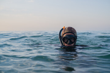 blue-eyed diver semi-submerged looking to the camera