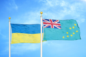 Ukraine and Tuvalu two flags on flagpoles and blue sky