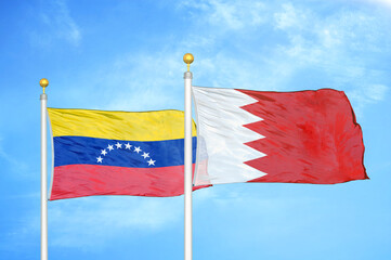 Fototapeta na wymiar Venezuela and Bahrain two flags on flagpoles and blue sky