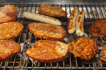 grilled steak and sausages on grill