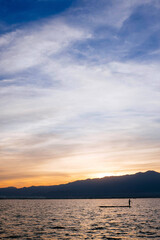 Sunset with a fisher on Lake Phayao in the North of Thailand.