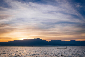 Sunset with a fisher on Lake Phayao in the North of Thailand.