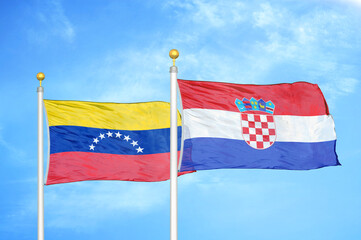 Venezuela and Croatia two flags on flagpoles and blue sky