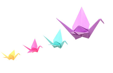 origami cranes flying on white background