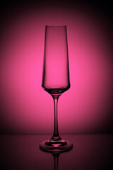 champagne glass on a pink gradient background