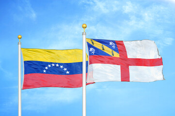 Fototapeta na wymiar Venezuela and Herm two flags on flagpoles and blue sky