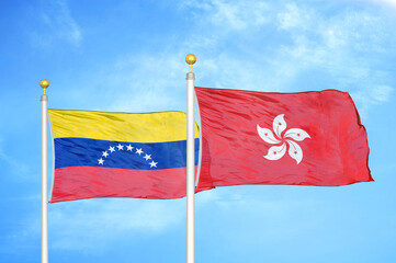 Fototapeta na wymiar Venezuela and Hong Kong two flags on flagpoles and blue sky