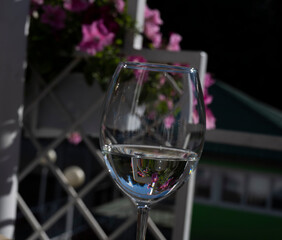 still life with a glass of white wine and external reflections