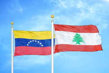 Fototapeta na wymiar Venezuela and Lebanon two flags on flagpoles and blue sky