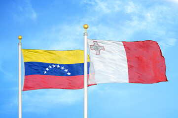Venezuela and Malta two flags on flagpoles and blue sky